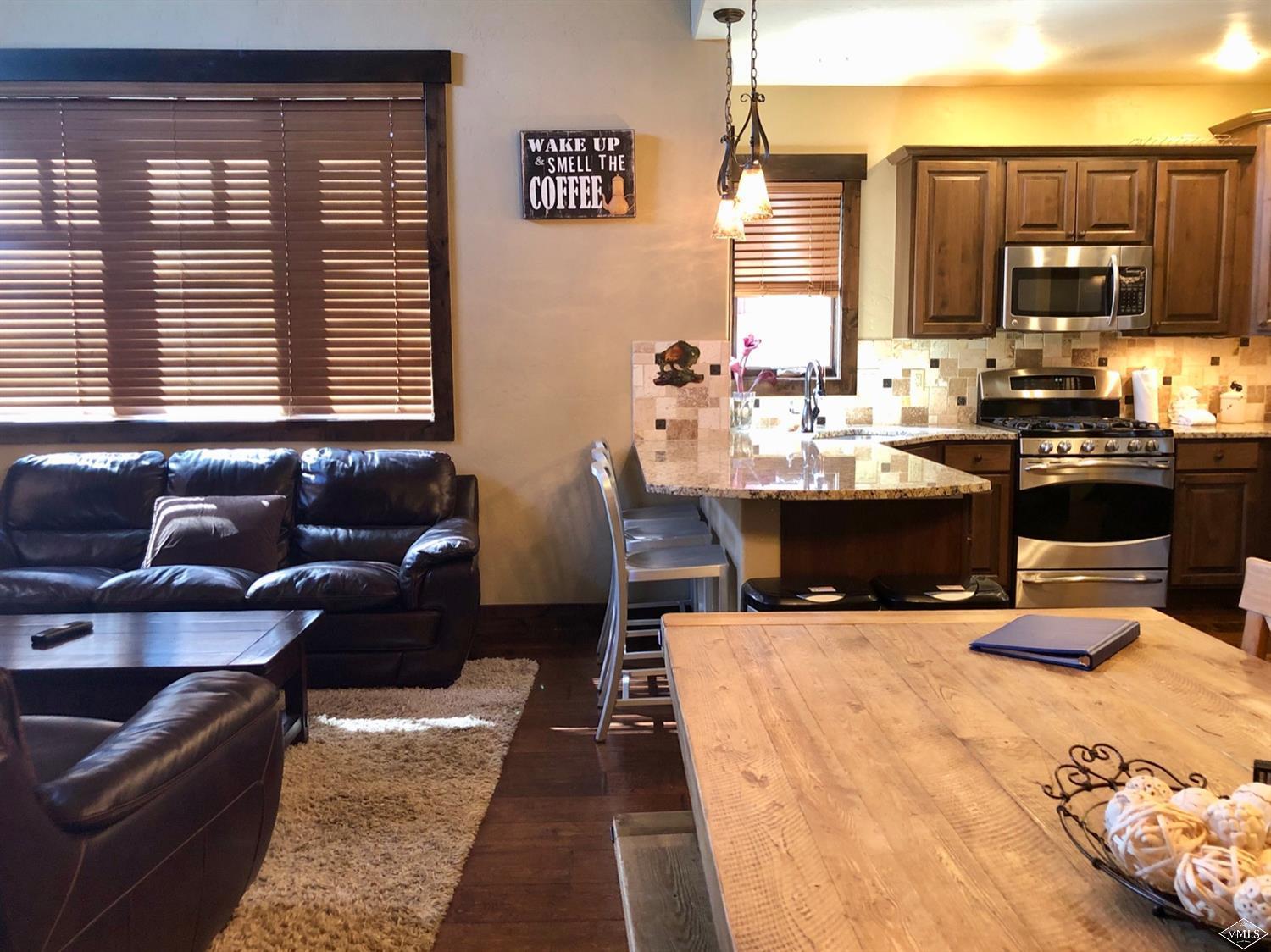60 County Road, Unit 60A Silverthorne, CO 80497 - Photo 2 of 21 a view of kitchen with stainless steel appliances kitchen island granite countertop a sink and cabinets