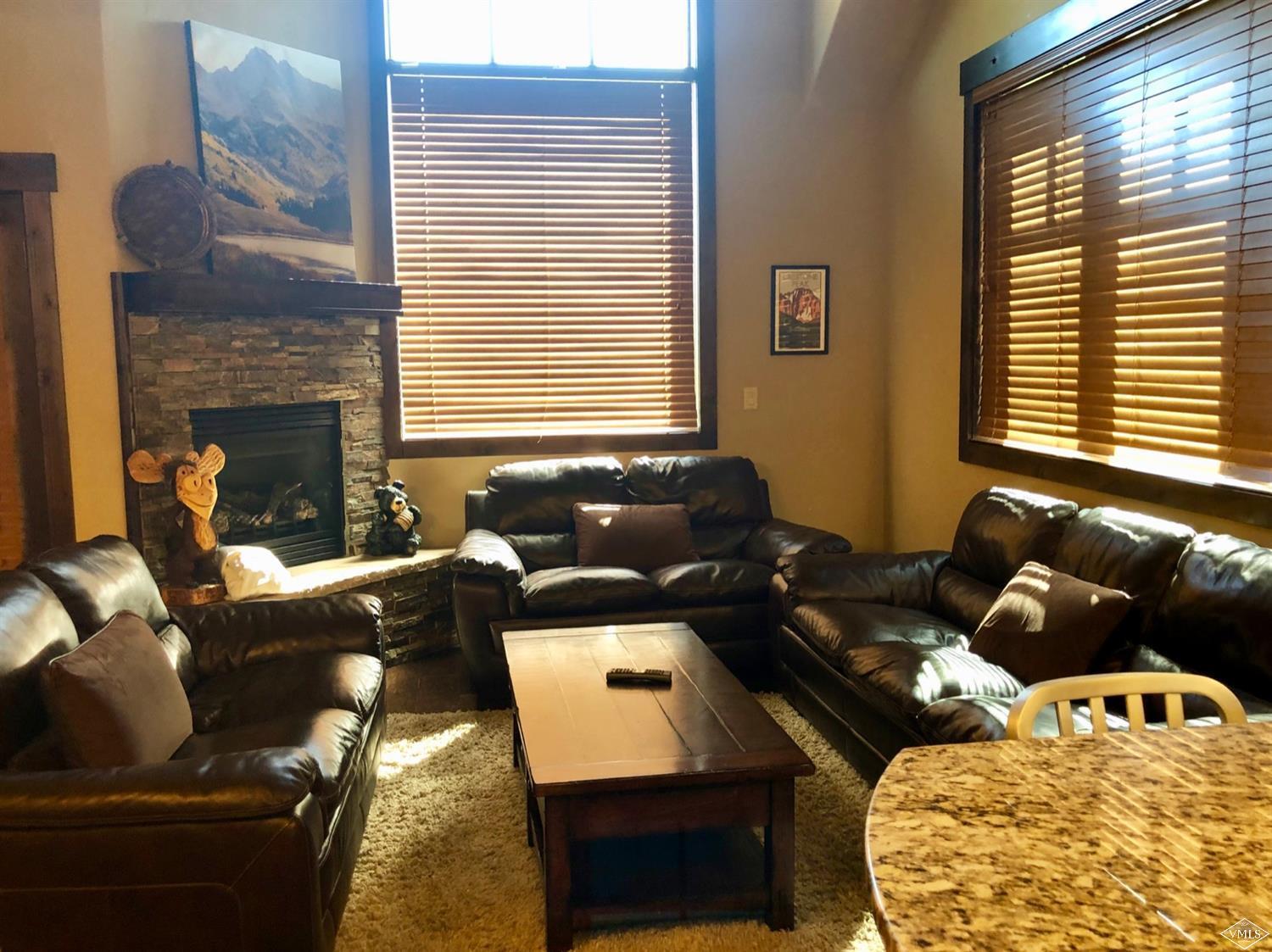 60 County Road, Unit 60A Silverthorne, CO 80497 - Photo 3 of 21 a living room with furniture and a fireplace