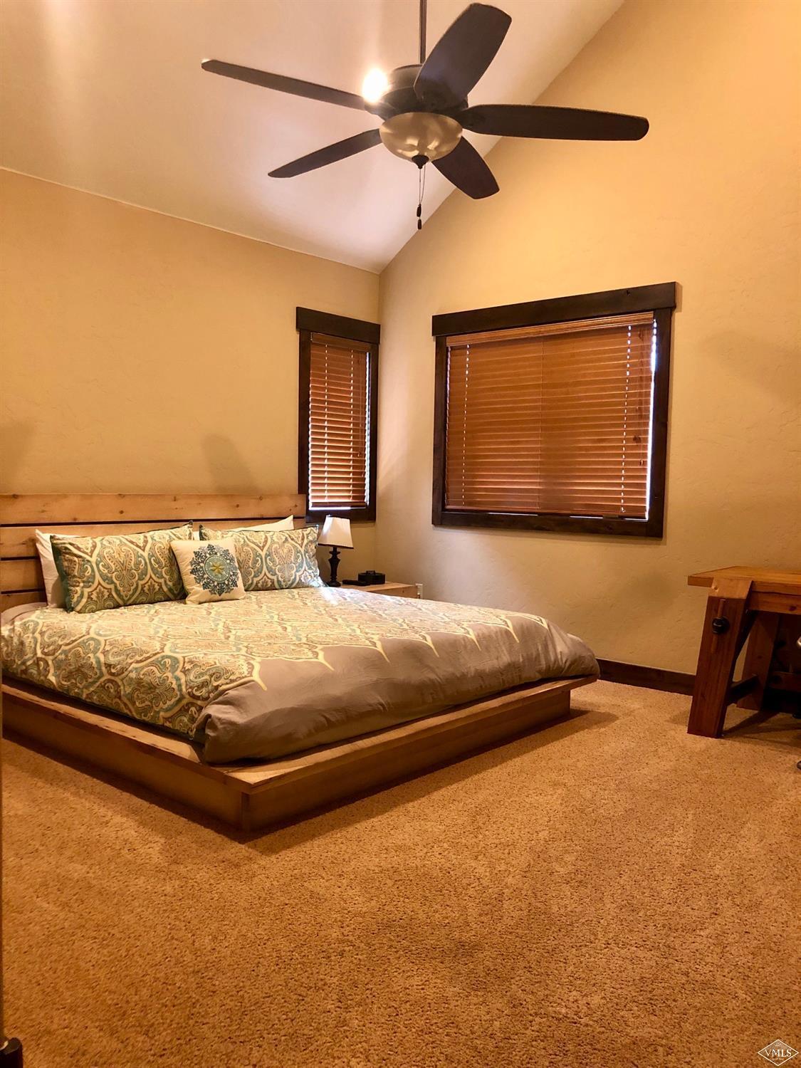60 County Road, Unit 60A Silverthorne, CO 80497 - Photo 8 of 21 a bedroom with a bed a ceiling fan and a rug
