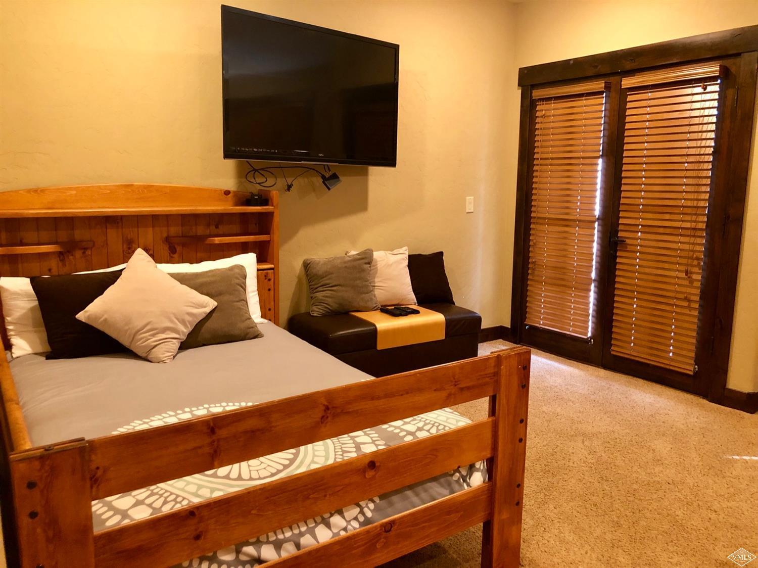 60 County Road, Unit 60A Silverthorne, CO 80497 - Photo 9 of 21 a bedroom with two beds and a flat screen tv