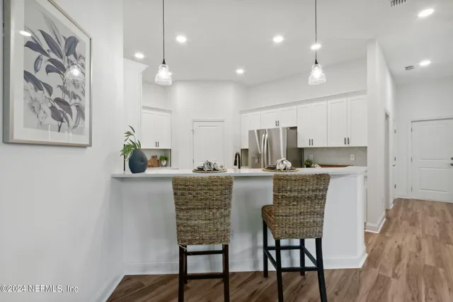a kitchen with a stove a sink and a refrigerator