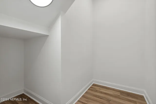 a kitchen with granite countertop white cabinets white stainless steel appliances and a sink