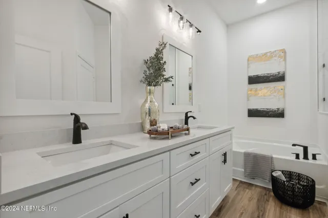 a bedroom with a bed a window and dresser