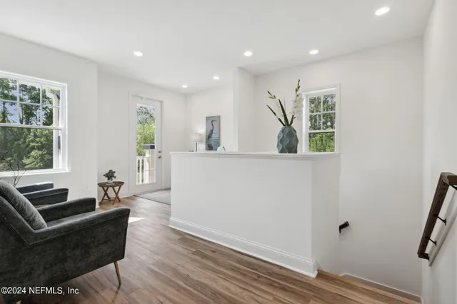 a view of entryway and hall with wooden floor