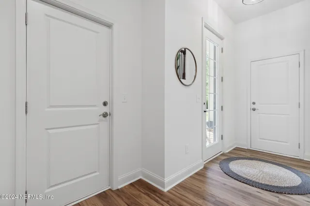 a bathroom with a granite countertop toilet and a sink