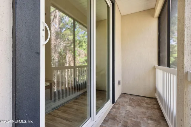 a view of hallway with wooden floor