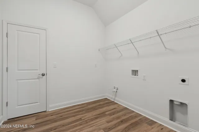 a view of a room with furniture and wooden floor