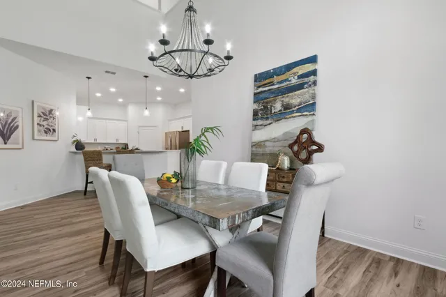 a view of a dining room with furniture wooden floor and chandelier