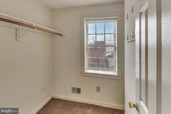 a spacious bedroom with a bed and a couch