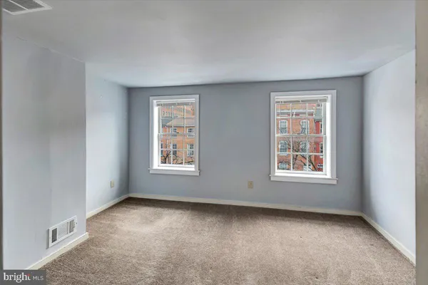 a bedroom with a bed and a chair