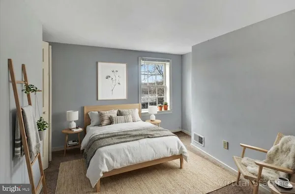 a bedroom with a bed and windows
