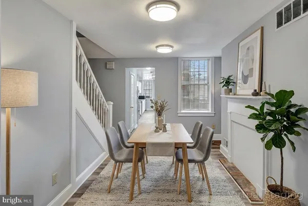 a dining room with furniture and potted plants