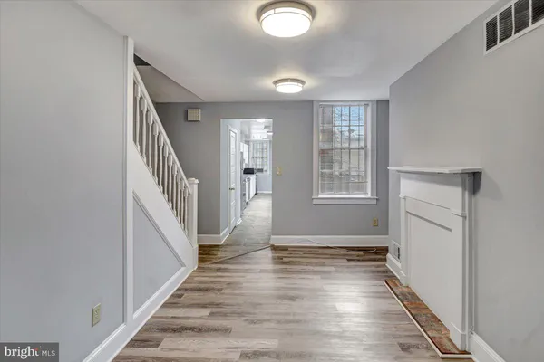 a view of an entryway with wooden floor and stairs
