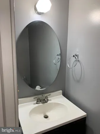 a bathroom with a sink and mirror