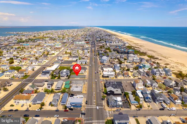 an aerial view of residential building and ocean view in back