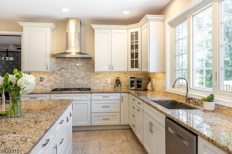 26 Mountain Ridge Drive Livingston, NJ 07039 - Photo 11 of 39 a kitchen with granite countertop a sink stove and cabinets