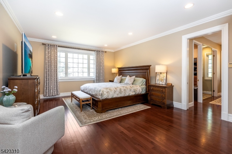 26 Mountain Ridge Drive Livingston, NJ 07039 - Photo 19 of 39 a bedroom with a bed and wooden floor