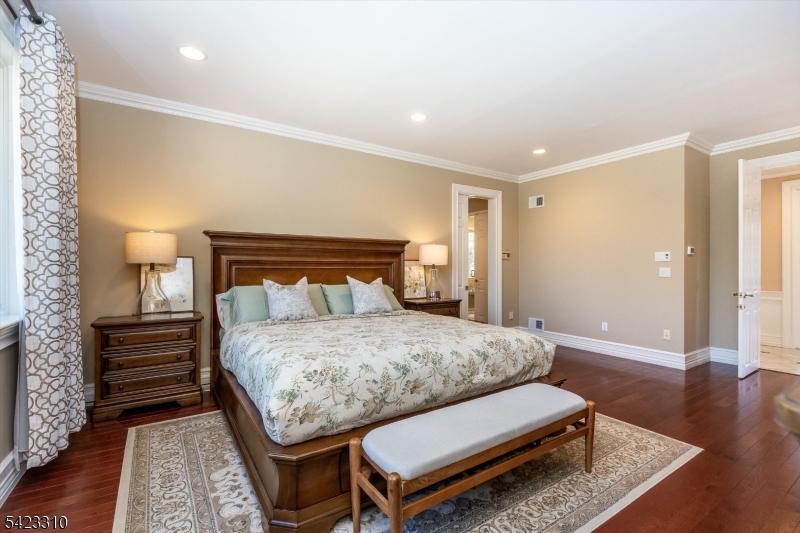 26 Mountain Ridge Drive Livingston, NJ 07039 - Photo 20 of 39 a bedroom with a bed and wooden floor