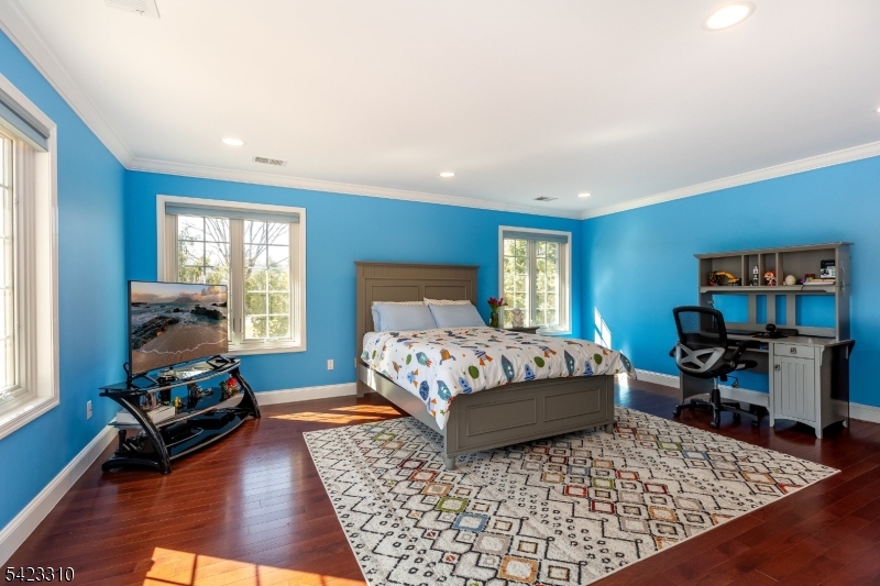 26 Mountain Ridge Drive Livingston, NJ 07039 - Photo 26 of 39 a bedroom with a bed wooden floor and windows