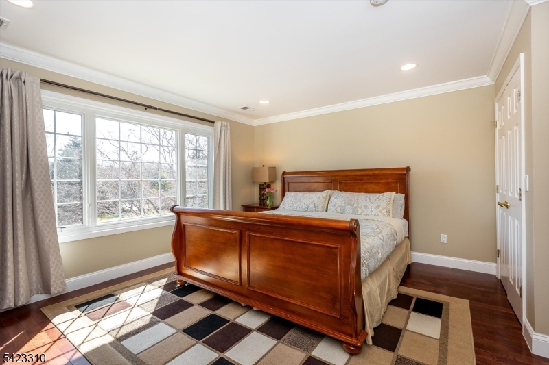 26 Mountain Ridge Drive Livingston, NJ 07039 - Photo 31 of 39 a bedroom with a bed and wooden floor