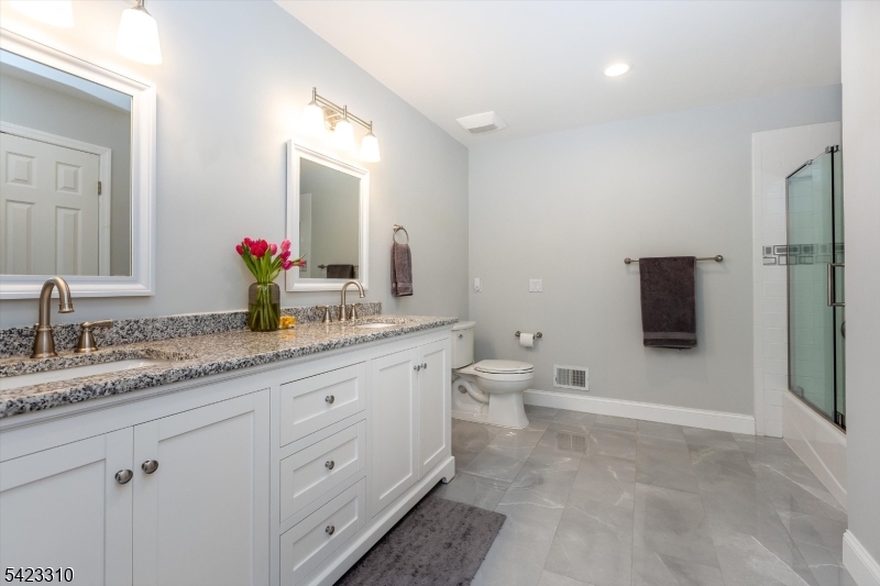 26 Mountain Ridge Drive Livingston, NJ 07039 - Photo 32 of 39 a bathroom with a granite countertop sink mirror and toilet