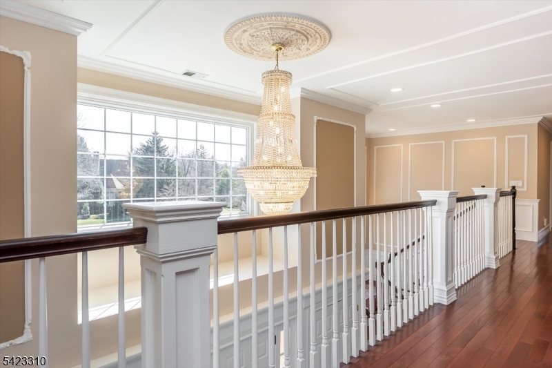 26 Mountain Ridge Drive Livingston, NJ 07039 - Photo 34 of 39 a view of hallway with wooden floor and a chandelier