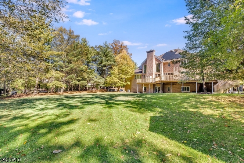 26 Mountain Ridge Drive Livingston, NJ 07039 - Photo 37 of 39 a view of a big building with a big yard and large trees