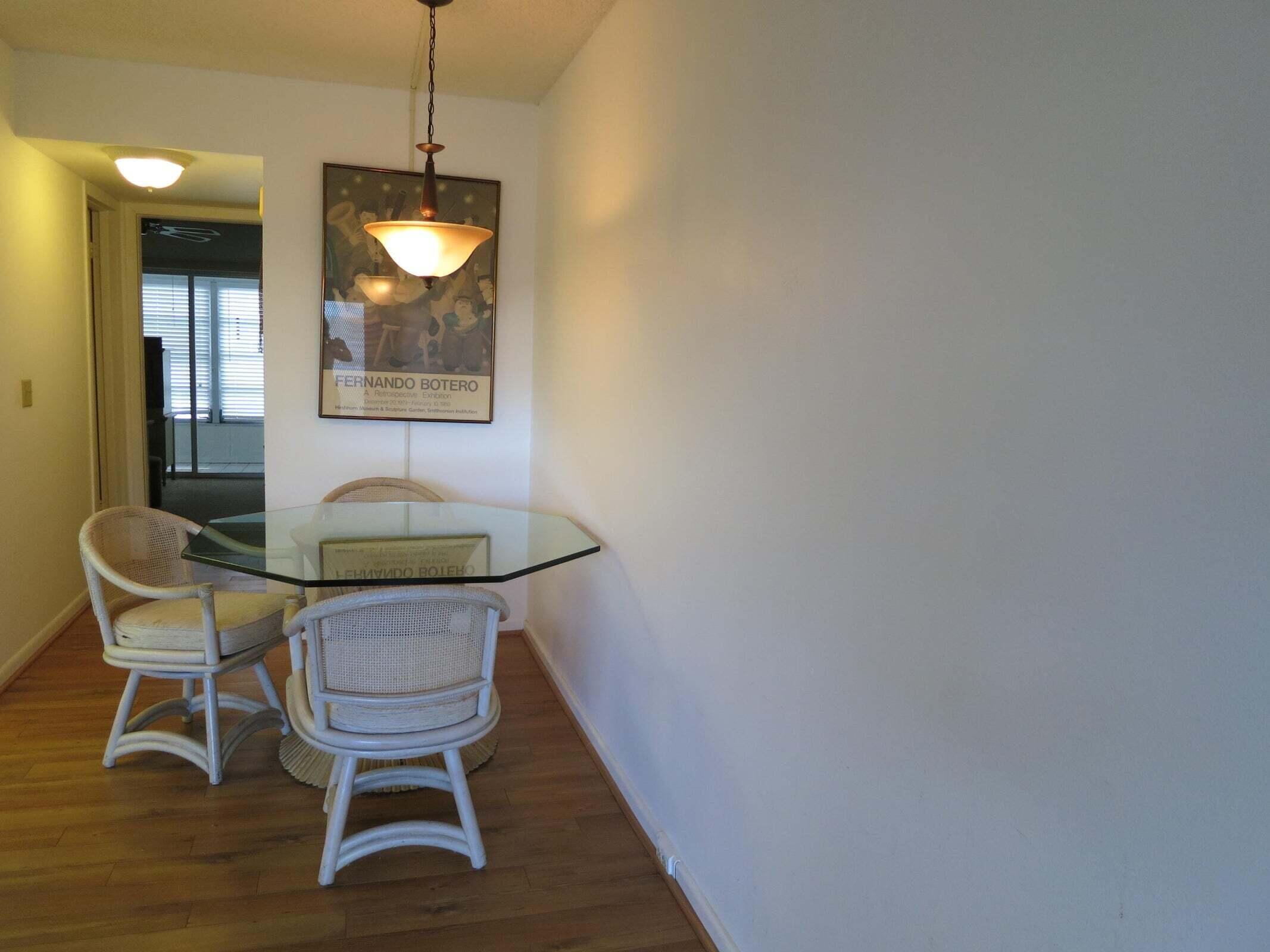 567 Fanshaw North Boca Raton, FL 33434 - Photo 3 of 8 a view of a dining room with furniture and wooden floor