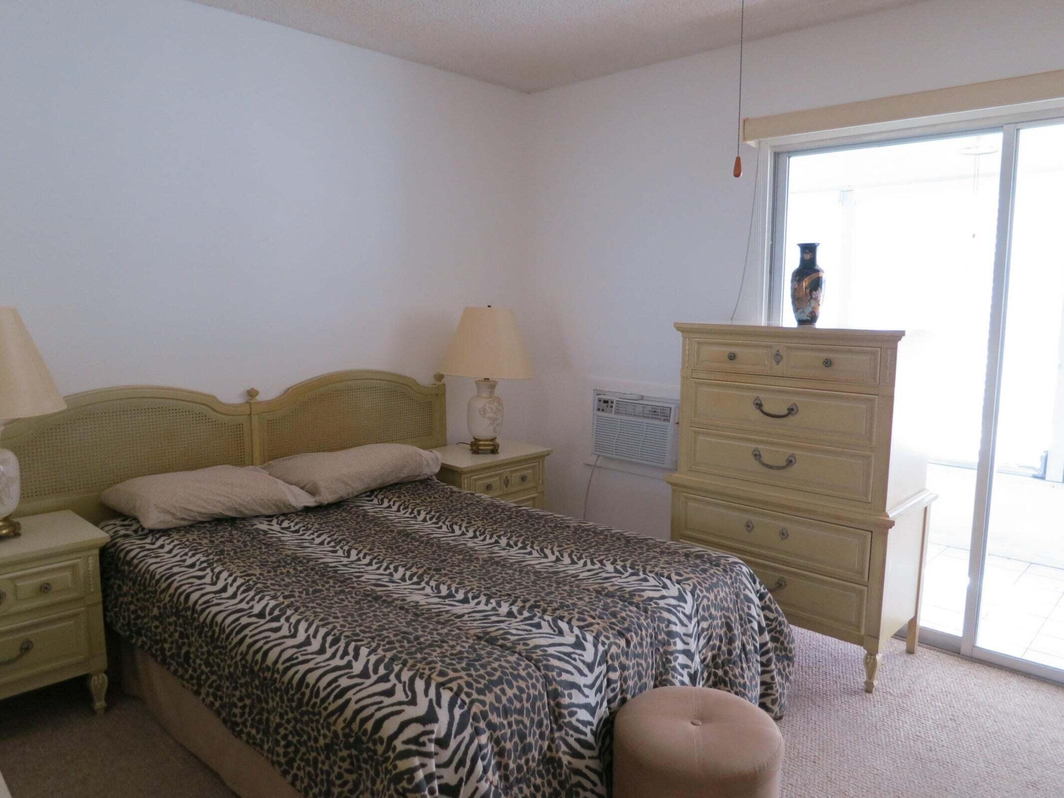567 Fanshaw North Boca Raton, FL 33434 - Photo 6 of 8 a bedroom with a bed and a mirror