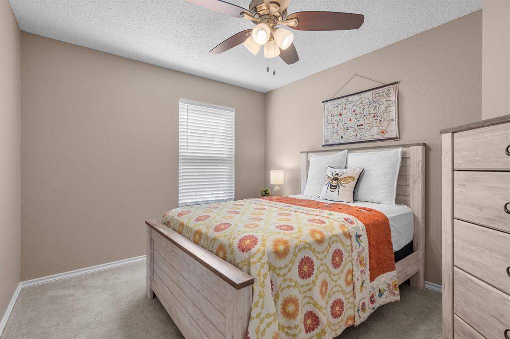 410 Simmons Road Double Oak, TX 75077 - Photo 27 of 40 Comfortable guest bedroom with neutral tones and easy bath access.