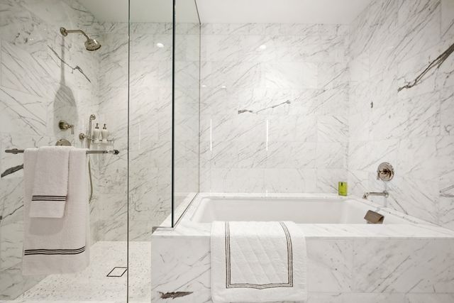 a bathroom with a bathtub and a shower