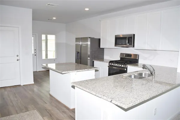 a kitchen with a sink stove and refrigerator