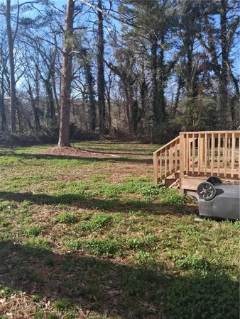 a view of a house with backyard and a tree