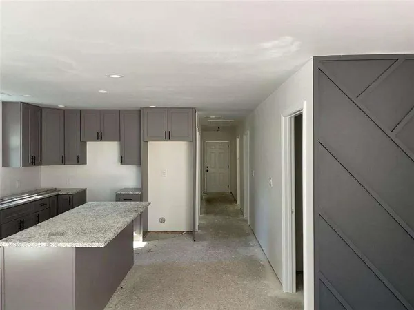 a kitchen with refrigerator and cabinets