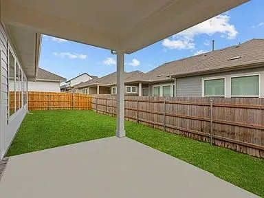 a view of a house with backyard and porch