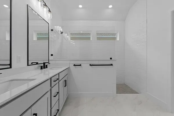 a bathroom with double sink and mirror