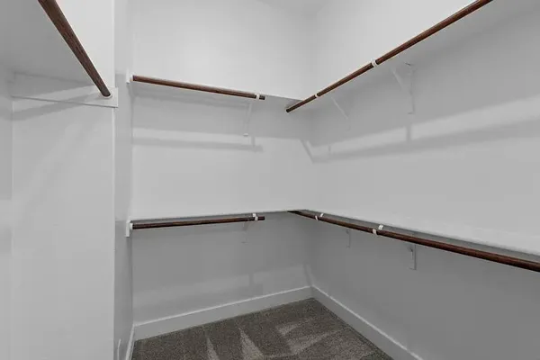 a bathroom with a double vanity sink a mirror and a shower