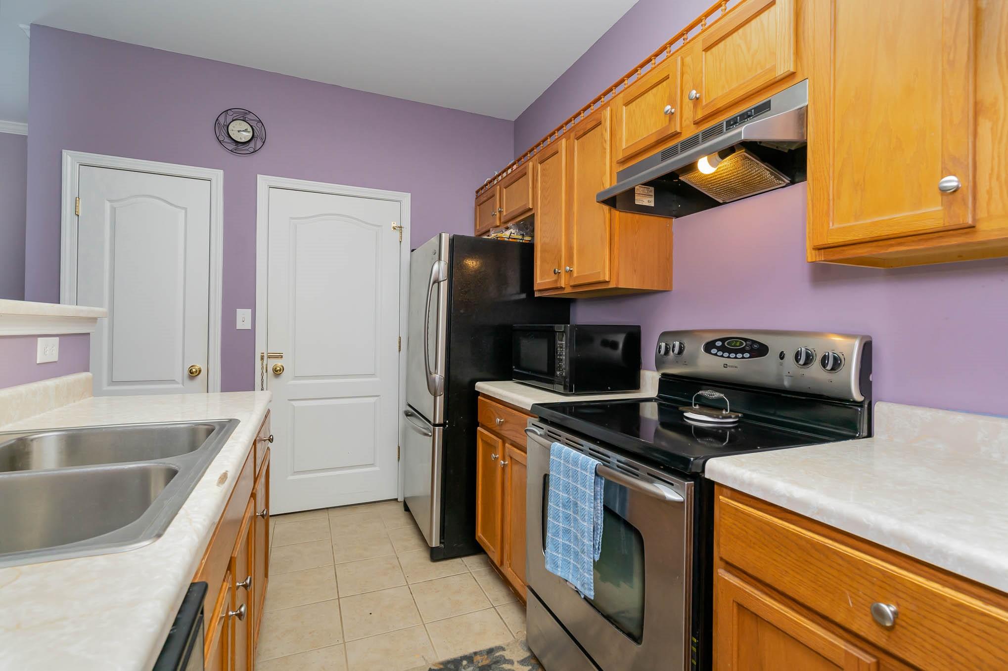 12832 Windyedge Road Huntersville, NC 28078 - Photo 11 of 28 a kitchen with stainless steel appliances granite countertop a sink and a stove