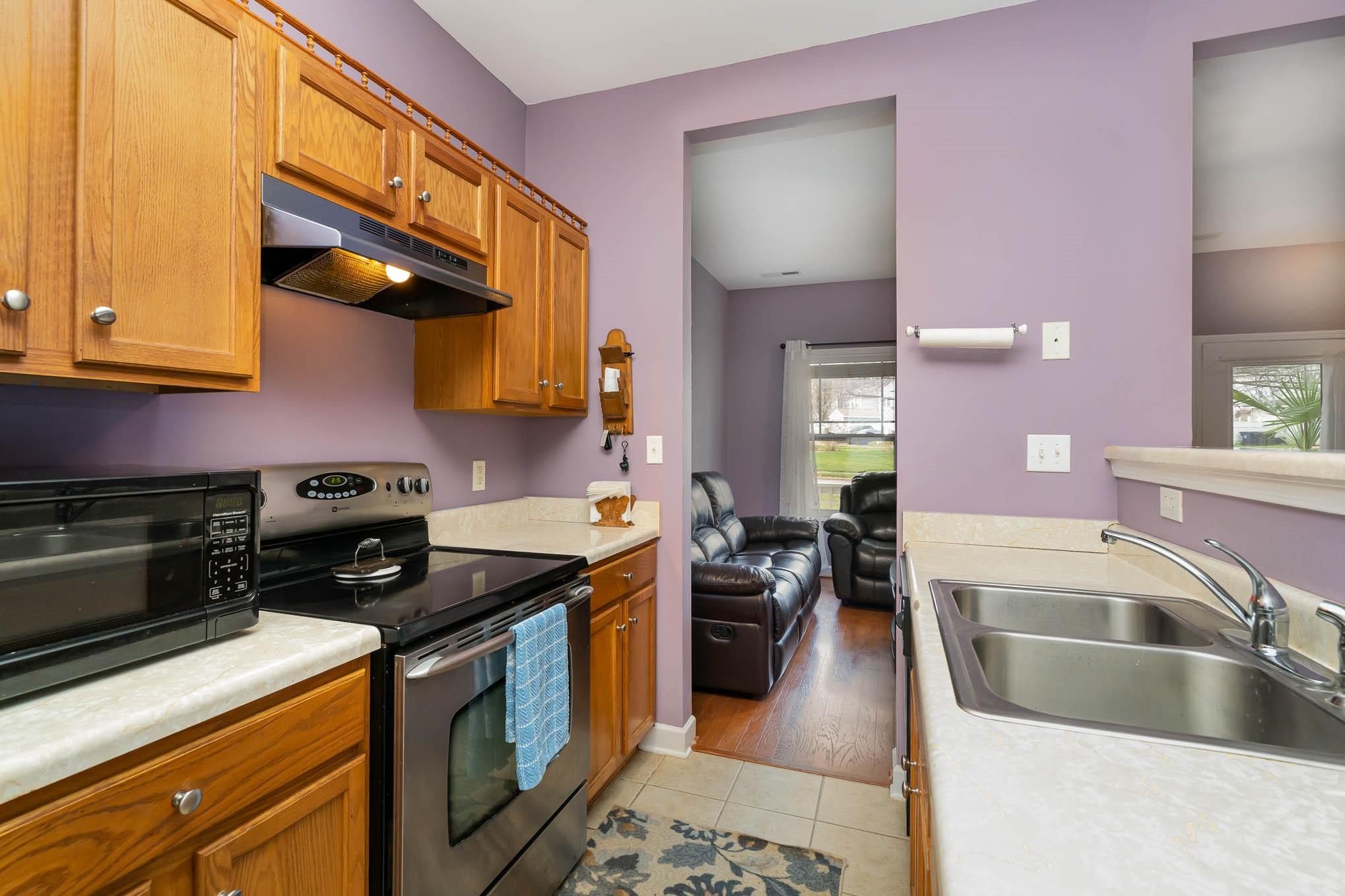 12832 Windyedge Road Huntersville, NC 28078 - Photo 12 of 28 a kitchen with stainless steel appliances granite countertop a stove a sink and a microwave