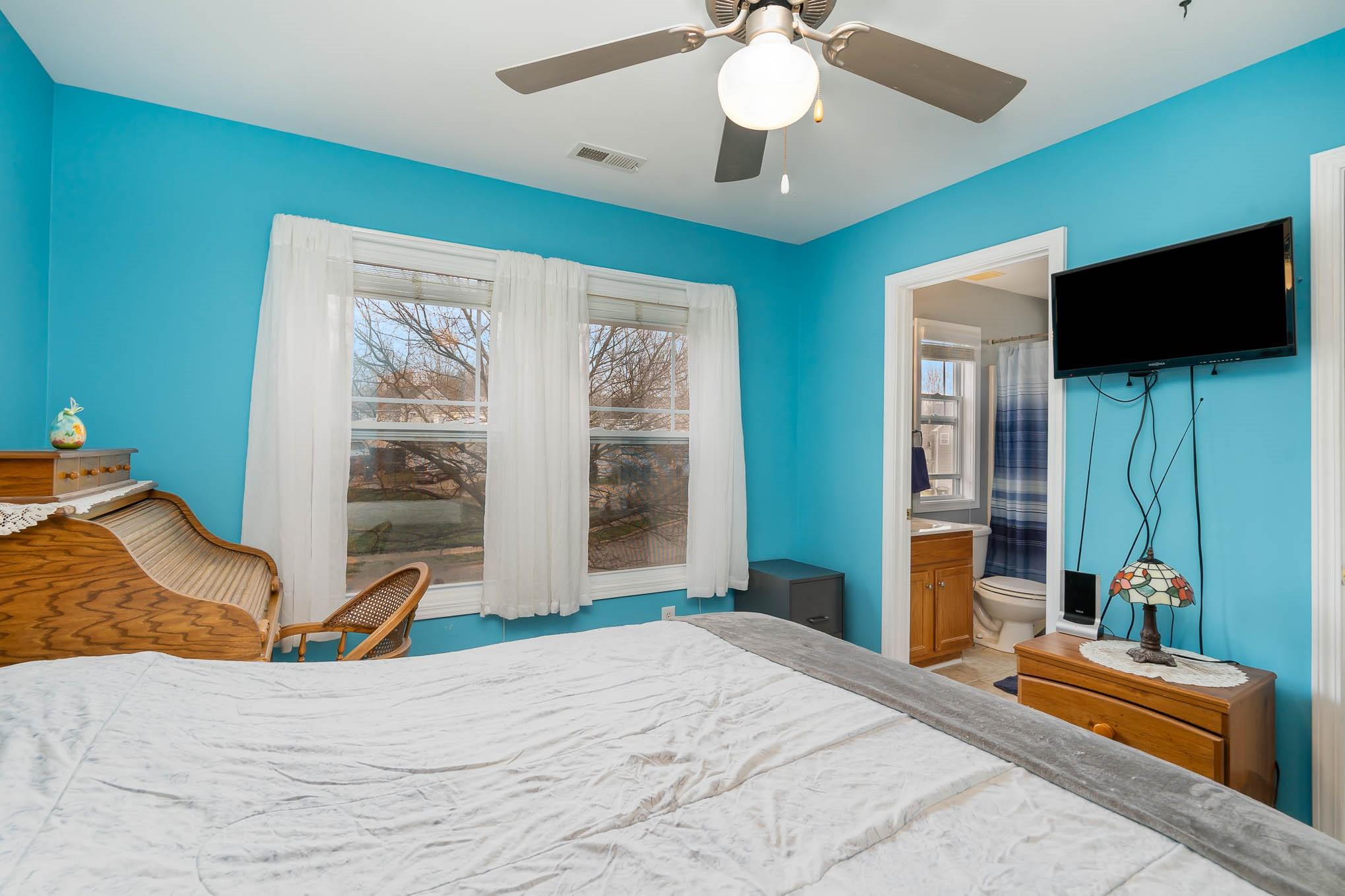 12832 Windyedge Road Huntersville, NC 28078 - Photo 15 of 28 a bedroom with a bed and a flat tv screen on dresser
