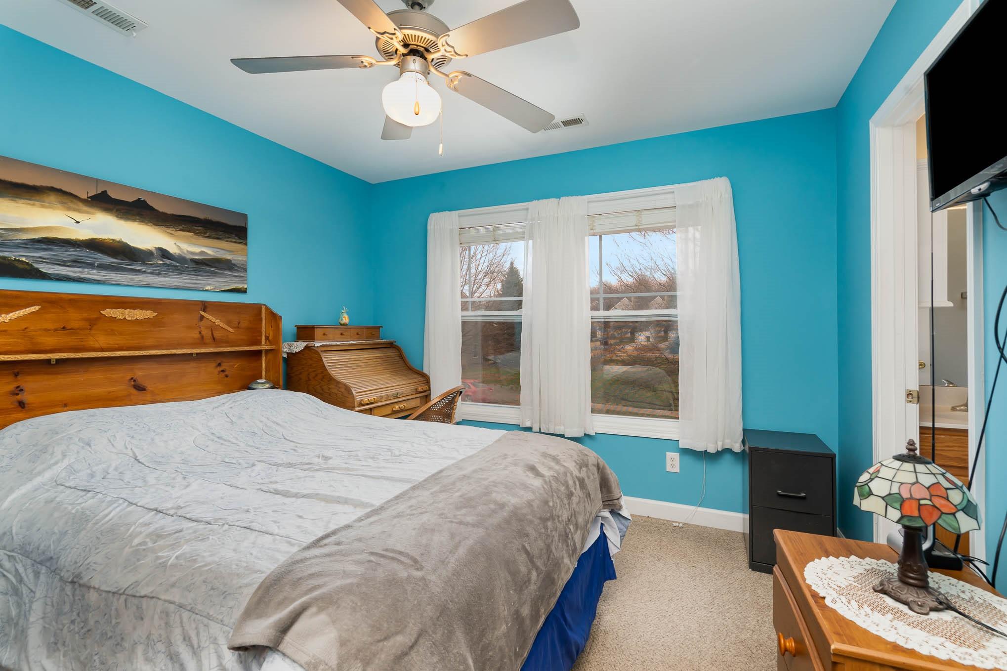 12832 Windyedge Road Huntersville, NC 28078 - Photo 18 of 28 a bedroom with a bed and a flat screen tv