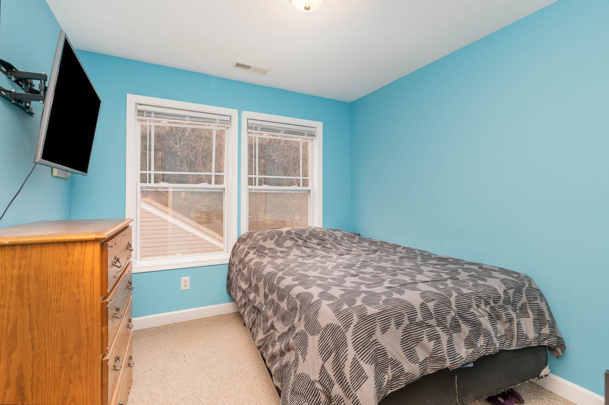 12832 Windyedge Road Huntersville, NC 28078 - Photo 20 of 28 a bedroom with a bed and a flat tv screen