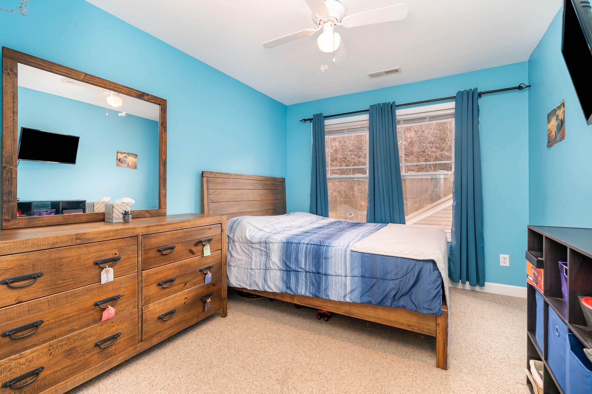 12832 Windyedge Road Huntersville, NC 28078 - Photo 22 of 28 a bedroom with a bed and a flat tv screen on dresser