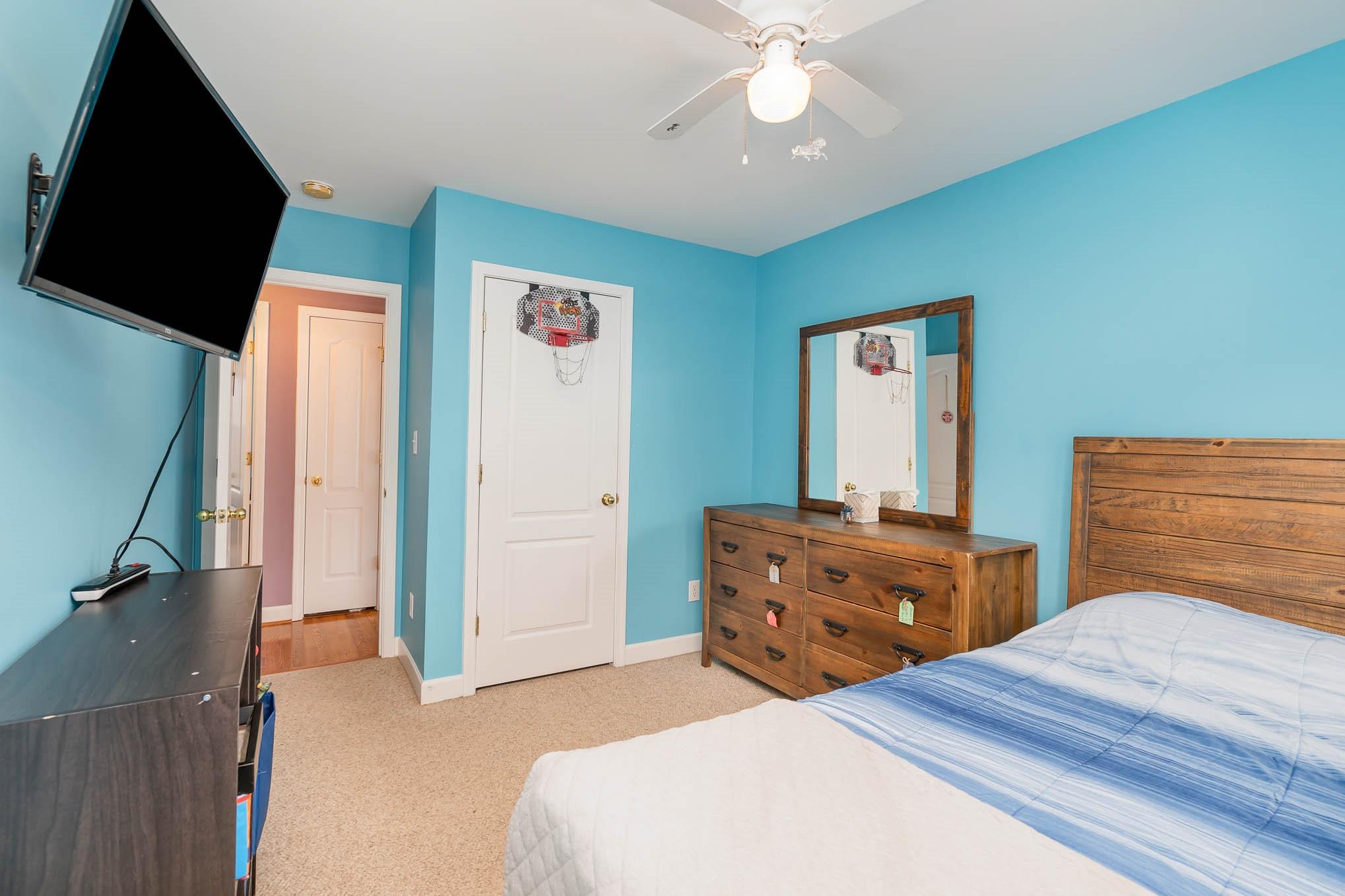 12832 Windyedge Road Huntersville, NC 28078 - Photo 23 of 28 a bedroom with a bed and a chandelier