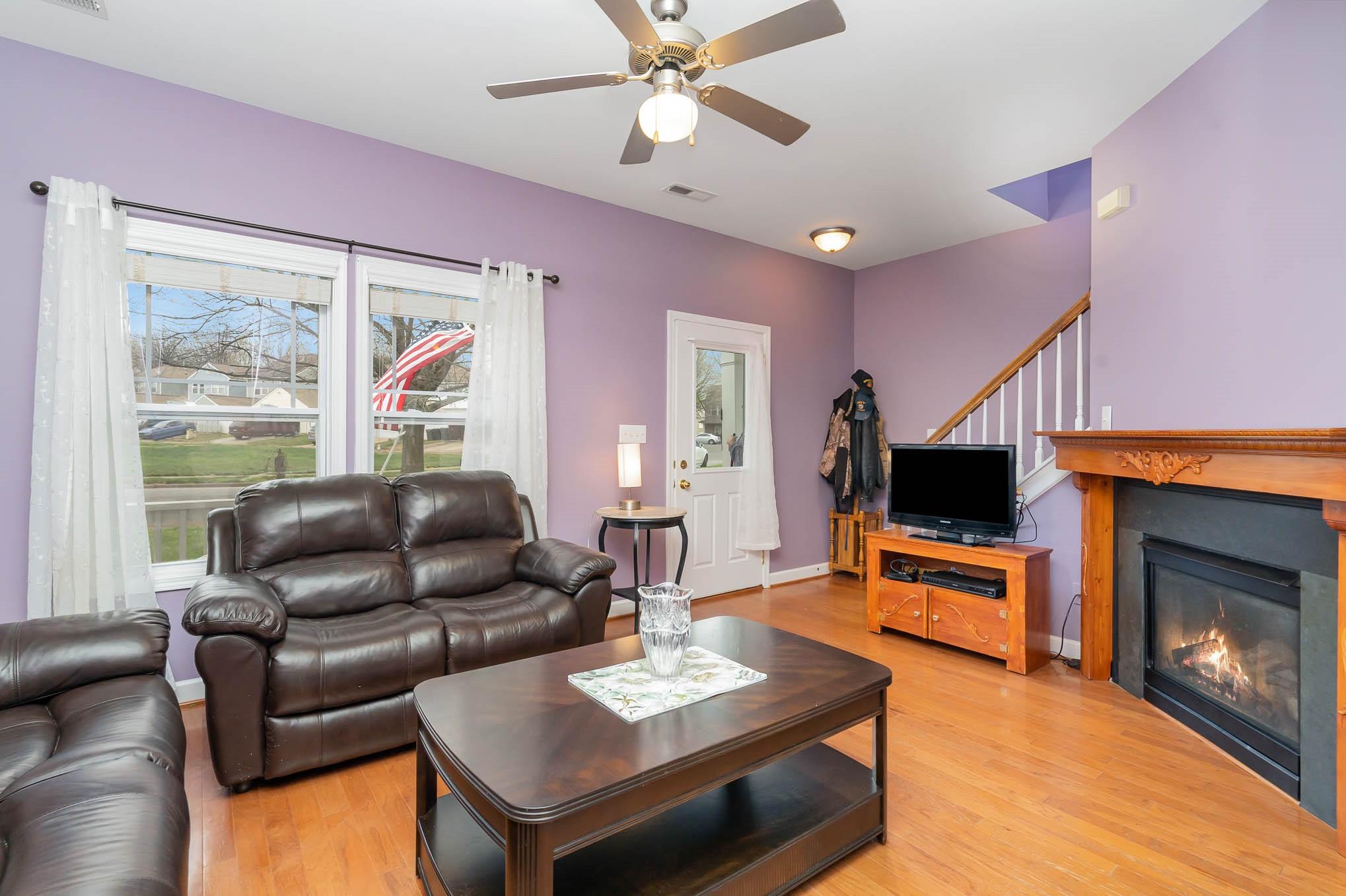 12832 Windyedge Road Huntersville, NC 28078 - Photo 3 of 28 a living room with furniture a fireplace and a flat screen tv