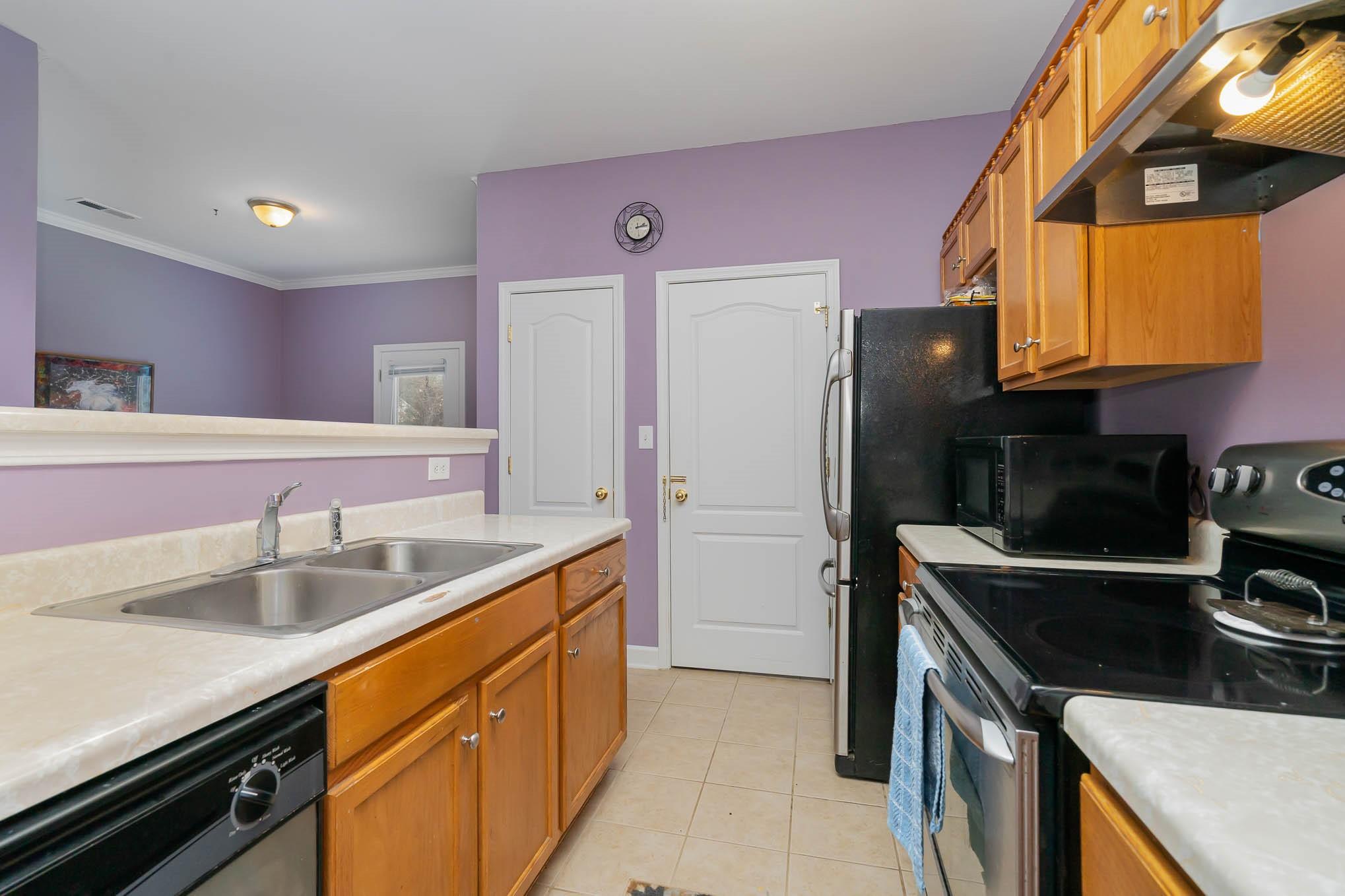 12832 Windyedge Road Huntersville, NC 28078 - Photo 4 of 28 a kitchen with a sink and a stove top oven