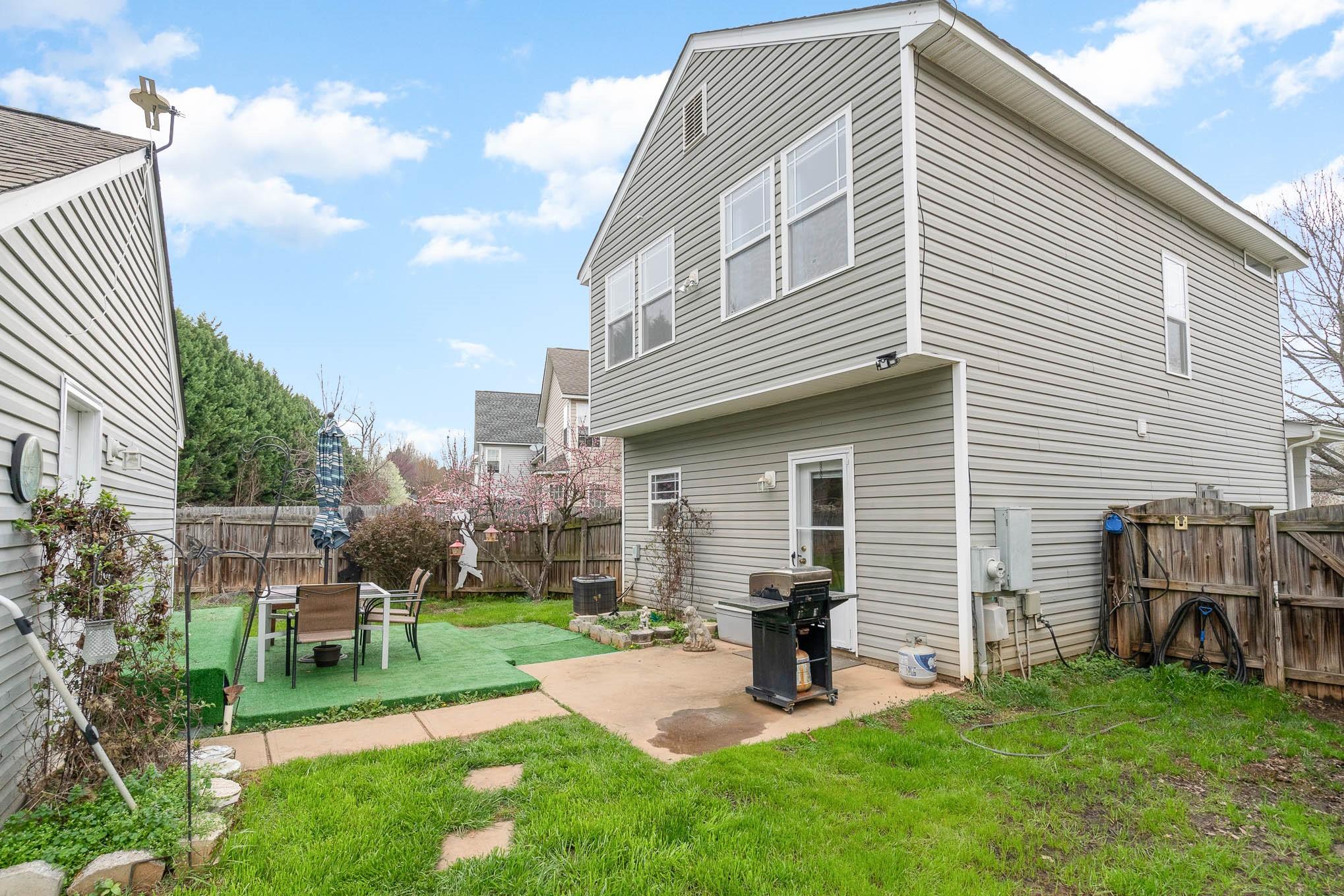12832 Windyedge Road Huntersville, NC 28078 - Photo 6 of 28 a view of a backyard with table and chairs and a barbeque