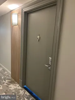 a view of hallway with sink and mirror