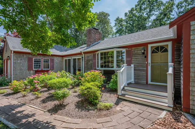 a front view of a house with a garden