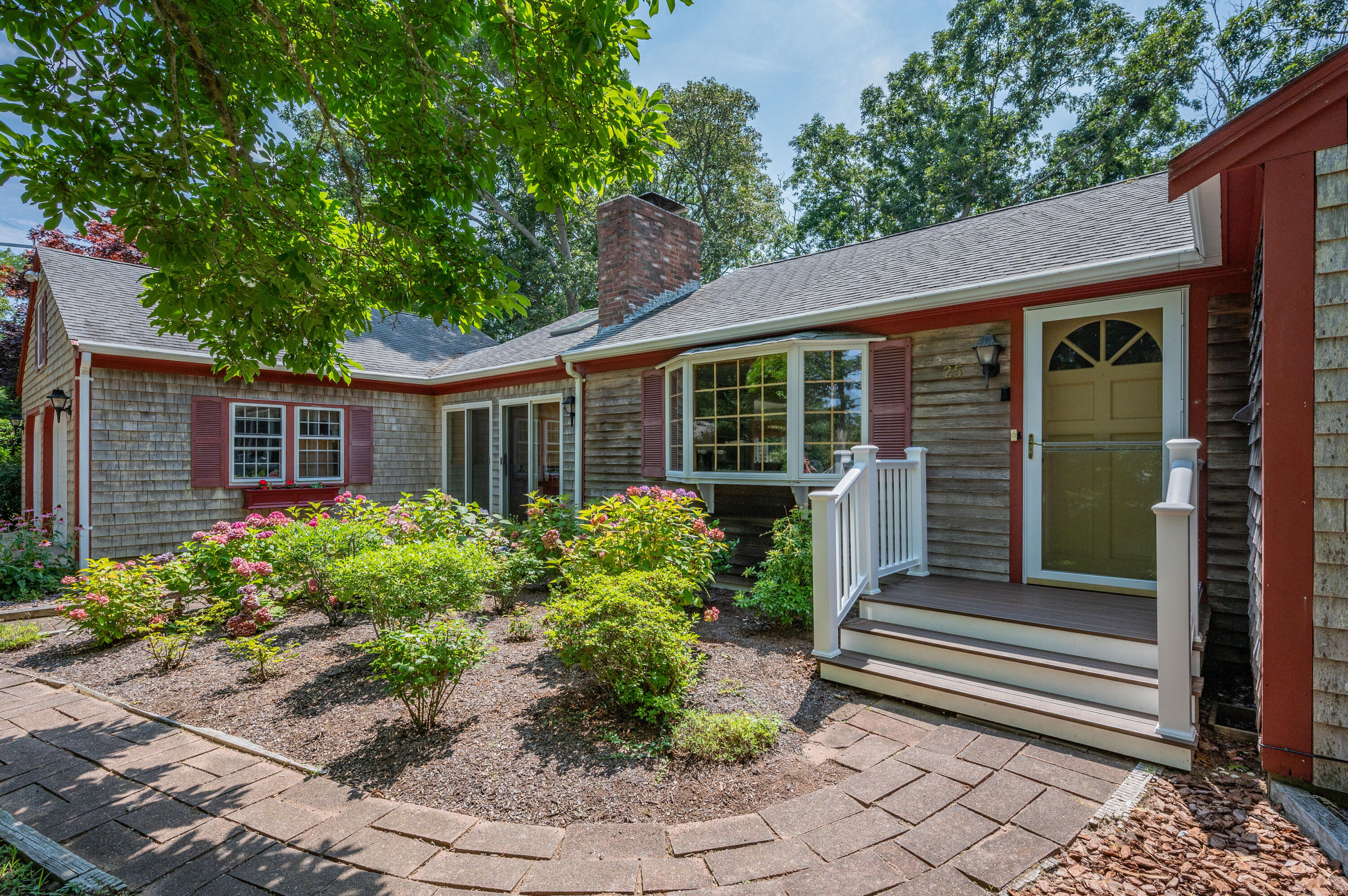 a front view of a house with a garden